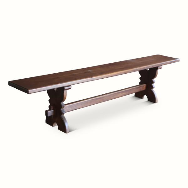 Dark brown wooden bench with rectangular tabletop and carved pedestal legs