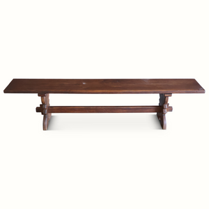 Dark brown wooden bench with straight backless seat and two central supports