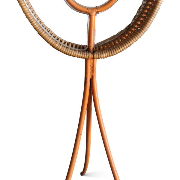 Floor lamp center post with woven rattan arc and three splayed wooden legs