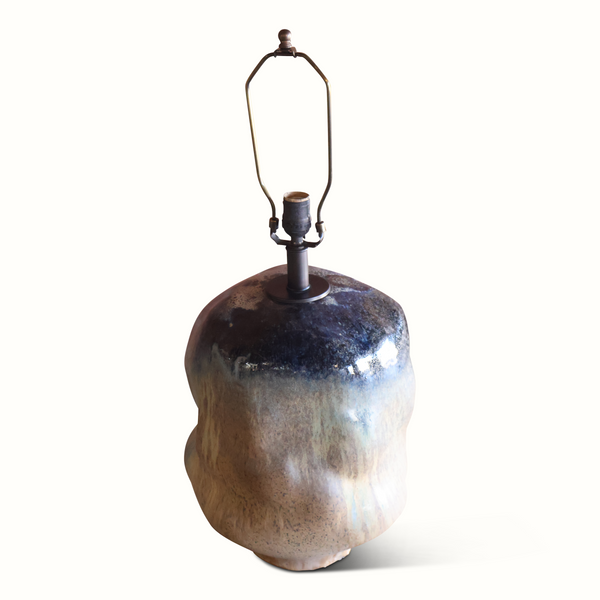 Brown glazed ceramic lamp base with off-white shade and exposed socket hardware