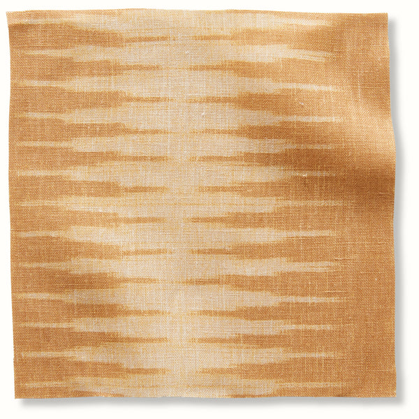 Gold ikat-style fabric pillow cover with abstract cream stripe pattern