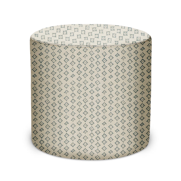 Round indoor pouf with cream base and repeating small geometric pattern, low profile