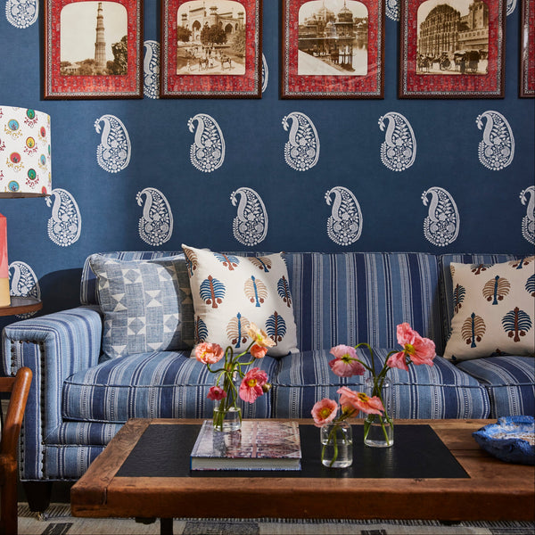 Blue upholstered sofa with patterned throw pillows and deep seat cushions