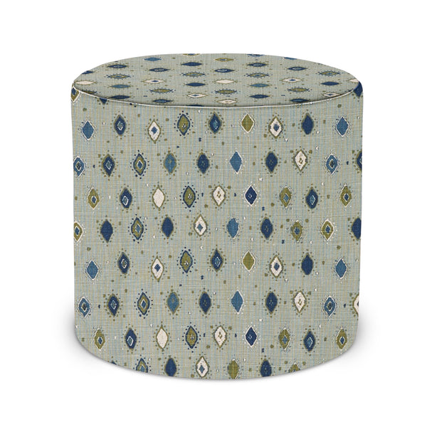 Round upholstered indoor pouf with blue and indigo geometric pattern fabric