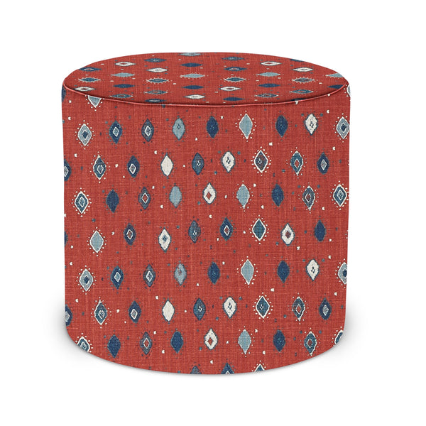 Red patterned upholstered indoor pouf with round top and cylindrical shape