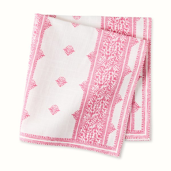 White napkin with pink stripe border and small repeating motif print