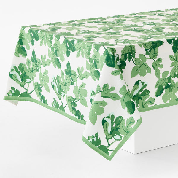 Leaf-printed tablecloth, green foliage on white ground, draped on table
