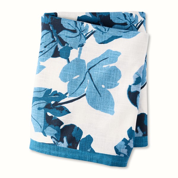 Fig leaf printed tablecloth, blue leaves on white ground, folded