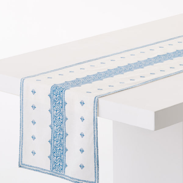 Patterned runner rug in blue on white with geometric border and small motif medallions