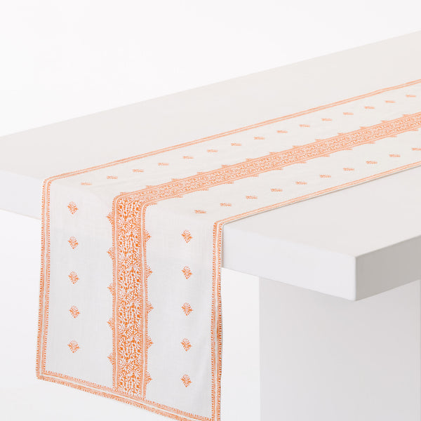 Orange-and-white printed runner rug with orange border and geometric motifs