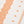 White runner rug with repeating orange medallion and dotted pattern