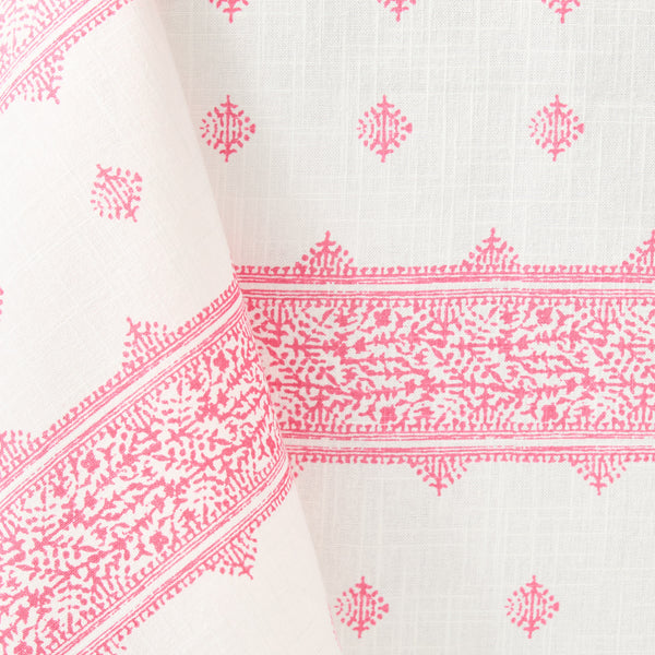 Pink printed motifs tablecloth corner with patterned border and stripes