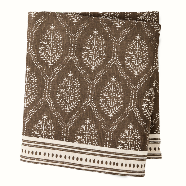 Chocolate brown printed tablecloth with white medallion pattern and striped border.