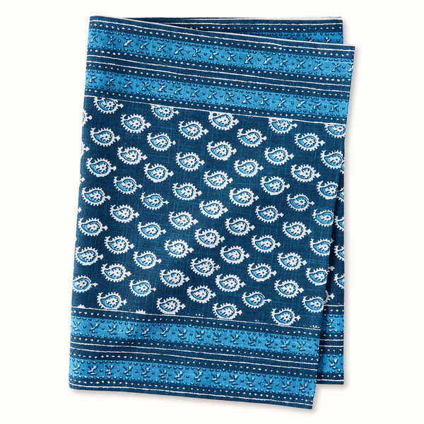 Blue printed runner rug with repeating gear-like medallion motifs and border stripes