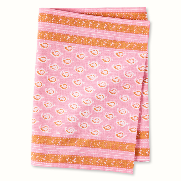Pink printed runner with repeating circular motifs and orange striped border edges.