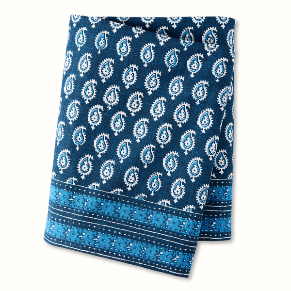 Blue printed tablecloth with white paisley teardrop motifs and striped border