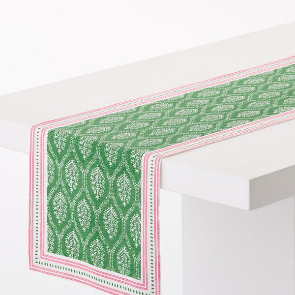 Green patterned runner corner with pink-and-white border, decorative jaali motif
