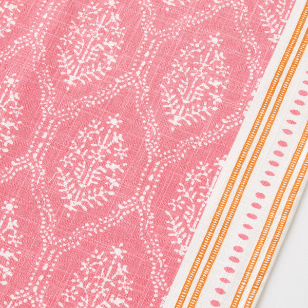 Pink jaali runner rug close-up with orange border and white geometric motif