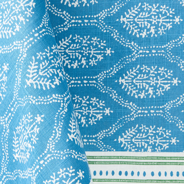 Blue tablecloth with white jaali geometric pattern, close-up fabric texture