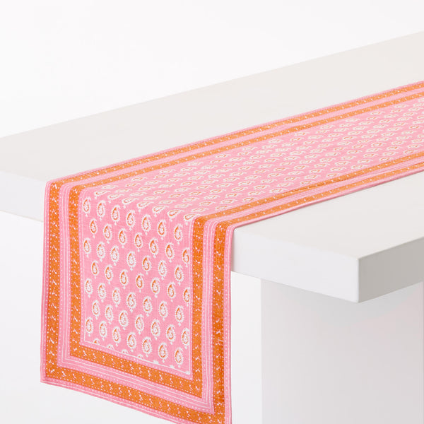 Pink printed runner with orange border and geometric motifs along the edge