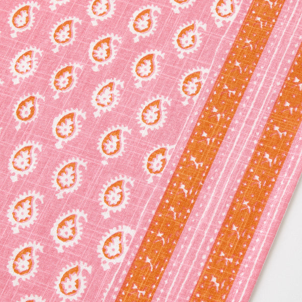 Pink printed runner with repeating medallions and orange striped panel close-up