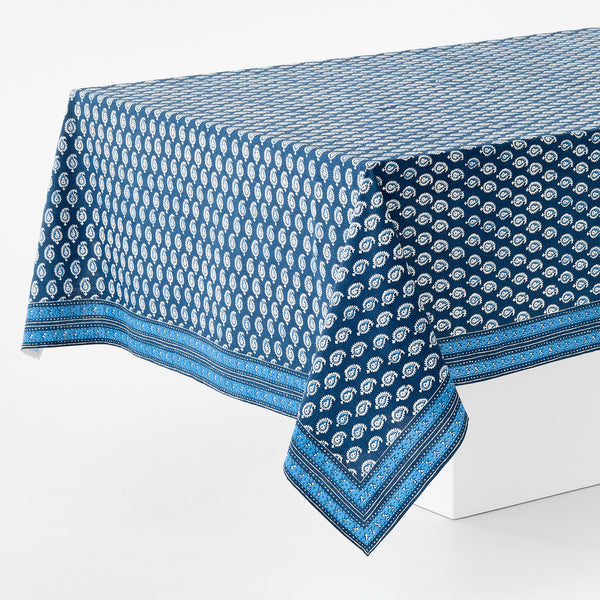 Blue printed tablecloth with paisley-like icons and bold border edge