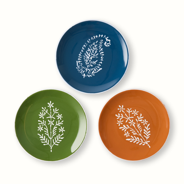 Assorted appetizer plates: blue, green, and orange with white tree branch motifs