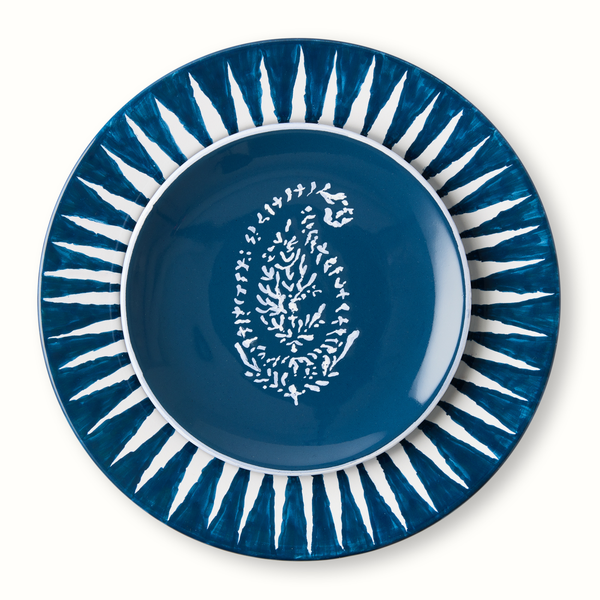 Indigo blue appetizer plate with centered white coral-like motif and radial blue border