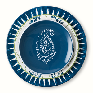 Indigo blue appetizer plate with white motif, surrounded by blue sunburst rim