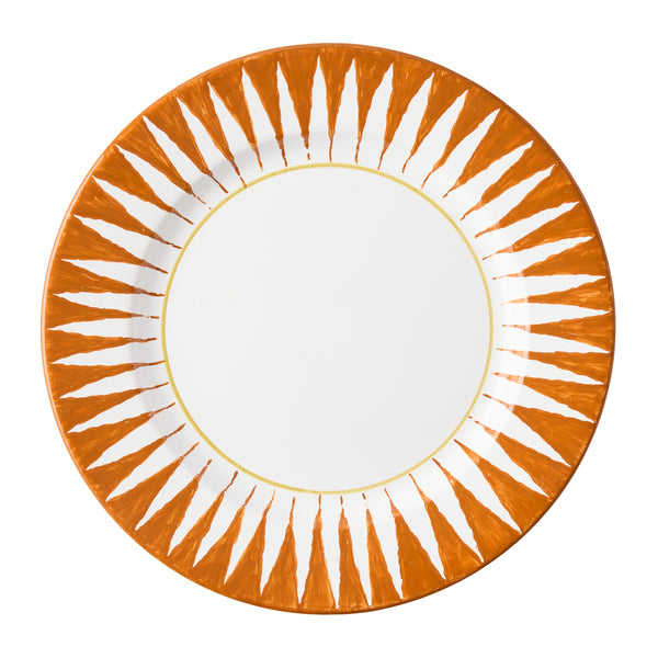 Orange sunburst dinner plate with white center and radial ray design