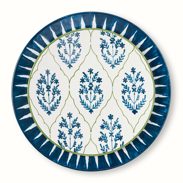 Blue-rimmed salad plate with blue botanical sprigs on white center and green outline