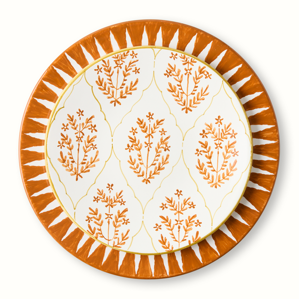 Orange jaali salad plate with white center, orange tree motif, and rays border