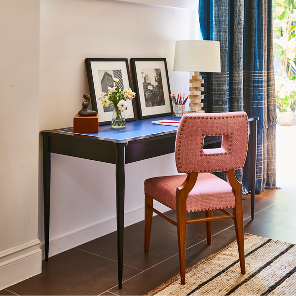 Upholstered side chair in rust red fabric with studded nailhead trim and dark wood legs