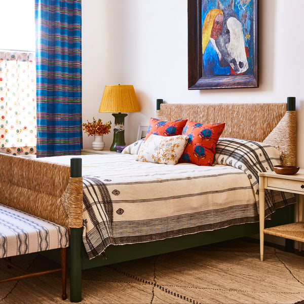 Perriand Rush Bed with light rush headboard and low rail, styled bedding with pillows