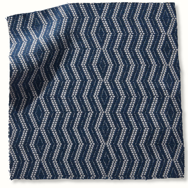 Indigo outdoor pillow cover with white geometric crisscross pattern