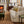 Sofa with patterned upholstery and rolled arms, styled with multiple printed throw pillows.