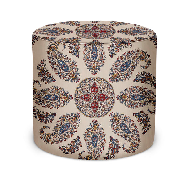 Indoor pouf with cylindrical shape, ornate blue and red paisley pattern on light fabric