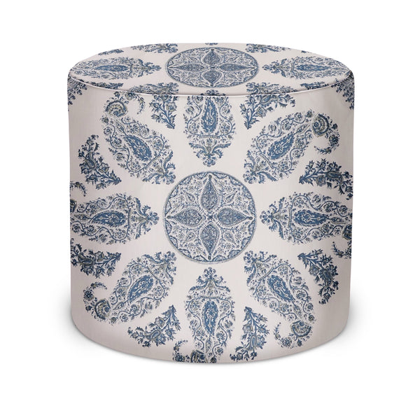 Indoor cylinder pouf with blue paisley pattern on white, upholstered fabric top
