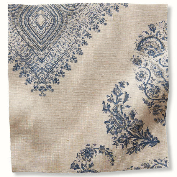 Blue and cream patterned fabric swatch with ornate floral and medallion motifs