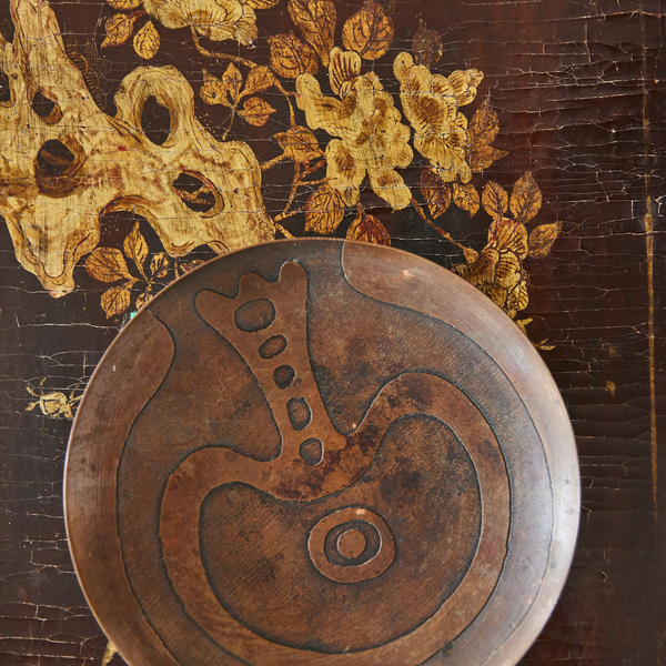 Gilt metal side table with decorative round inlay panel on dark tabletop
