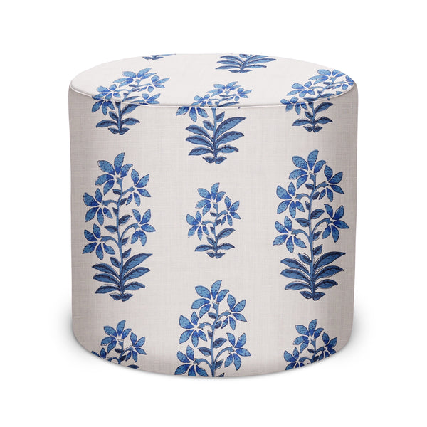 Indoor fabric pouf with indigo blue floral pattern on light background, round cylinder