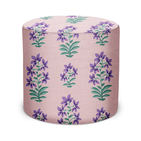 Indoor pouf in Shani fabric, light pink with purple floral pattern and green leaves.
