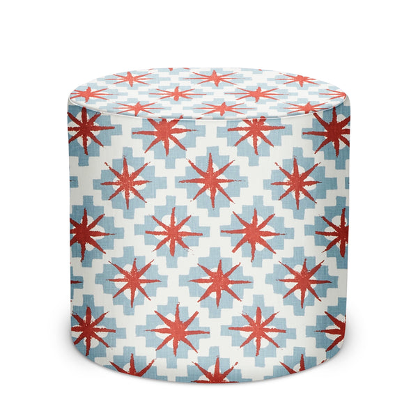 Starburst patterned indoor pouf, blue fabric with red starburst print, round cylinder
