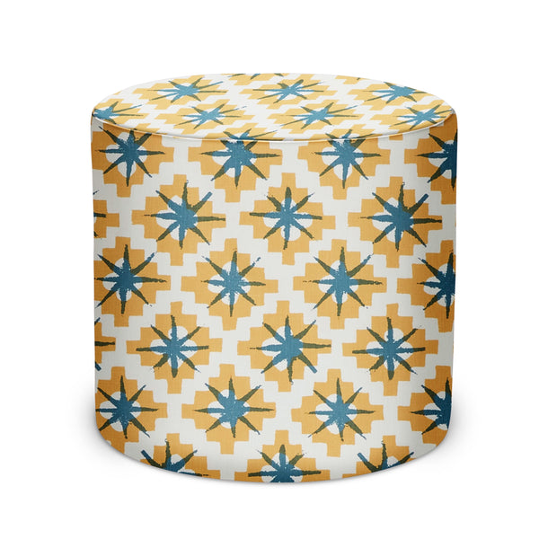 Indoor pouf with yellow base and blue starburst pattern, round cushioned top.