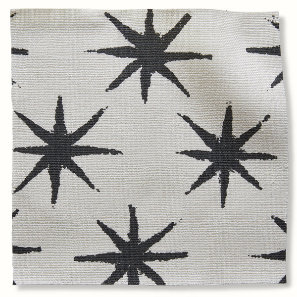 Charcoal starburst pattern on light woven decorative pillow cover