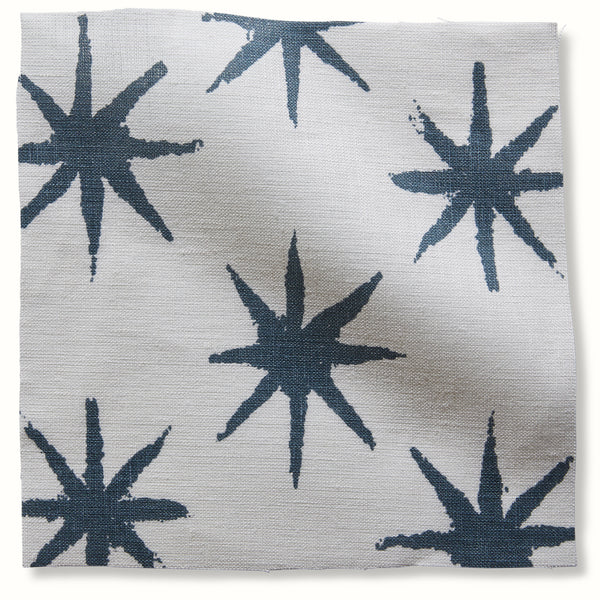 Indigo starburst pattern pillow cover with navy-style stars on light fabric