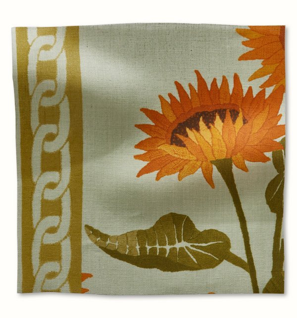 Light blue decorative pillow with orange sunflower vine and leaf print