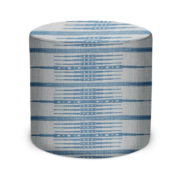 Indoor cylindrical pouf in mist fabric with blue striped geometric pattern.