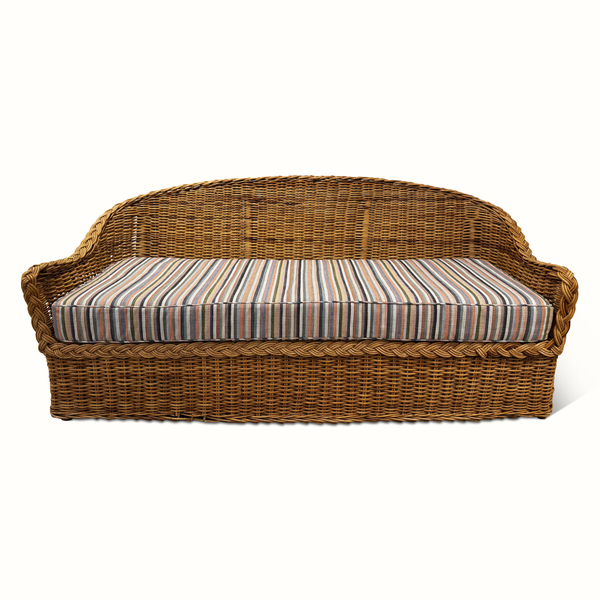 Wicker sofa with striped cushion, tan-brown frame and multicolor striped upholstery