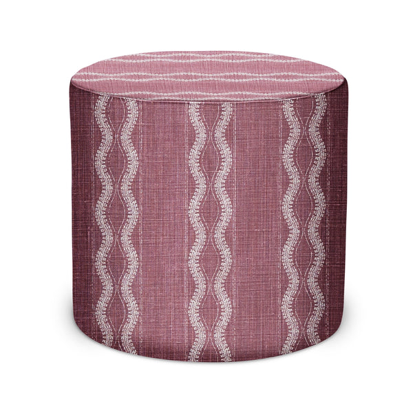 Cylindrical upholstered pouf in mauve with white wavy pattern and flat top